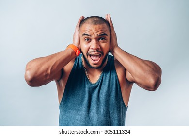 Black Man Covers His Ears And Shouts