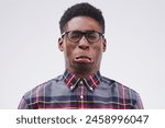 Black man, crazy and emoji face in studio for silly, comedy and funny by white background. Male person, emotions and expression for joke, prank and comic for humour and laugh isolated on backdrop
