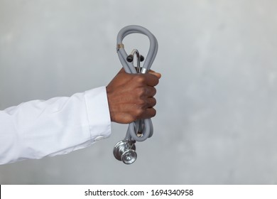 Black man doctor hand holding stethoscope is ready to fight against the COVID, COVID-19, coronavirus, pandemic, epidemic, virus. Concept of humanitarian assistance to African countries