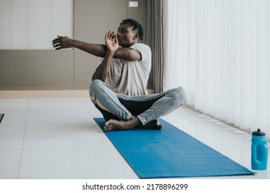 Black Man Doing Shoulder Stretching Exercise At Home. Workout At Home 