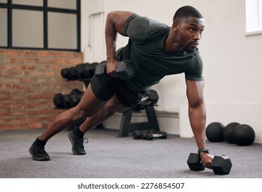 Black man, dumbbell row and training in gym, workout and strong fitness in health club. Serious sports athlete, bodybuilder and weight exercise on ground for energy, power and core strength challenge