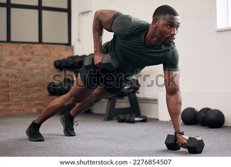 Black man, dumbbell row and training in gym, workout and strong fitness in health club. Serious sports athlete, bodybuilder and weight exercise on ground for energy, power and core strength challenge
