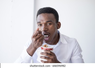 Black Man Eating Ice Cream With Spoon