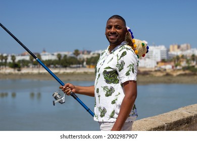 A Black Man Fishing On The Bridge