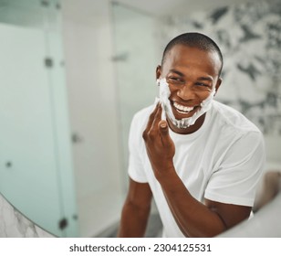 Black man, foam and happy for shaving, grooming and cosmetics in mirror for self care in home. Young african guy, soap or cream for facial hair, beard and cleaning for hygiene with smile in morning - Powered by Shutterstock