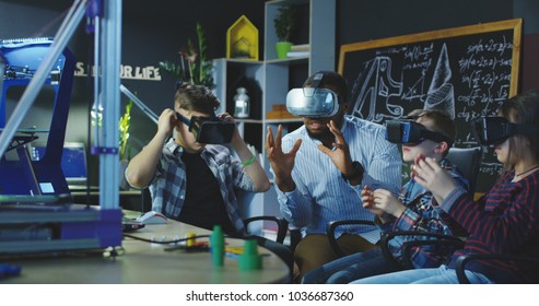 Black man with group of kids having lesson about 3d modeling wearing VR glasses in lab. - Powered by Shutterstock