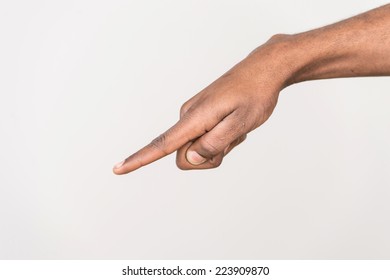 Black Man Hand On White Background. Isolated African Male Hand Touching Or Pointing To Something