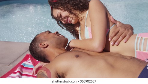 Black Man And Hispanic Woman Kissing By The Pool In Love