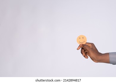 Black Man Holding Cardboard Cutout Smiling Emoji Face