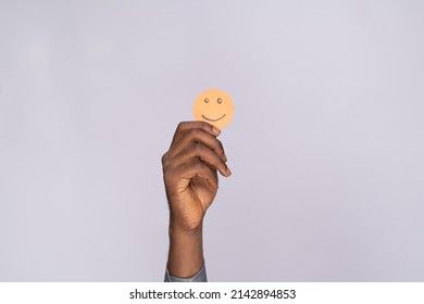 Black Man Holding Cardboard Cutout Smiling Emoji Face