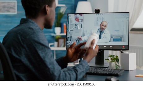 Black man at home seeking medical help from doctor via online intenet telehealth consultation with family doctor. Health care checkup via video virtual conference, patient looking for medicine advice
