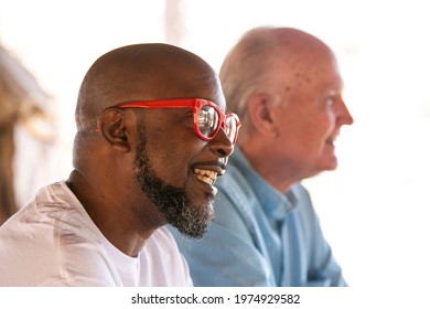 Black Man Living With HIV Sitting Beside An Older Caucasian Man