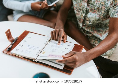 Black Man Looking At His Weekly Planner