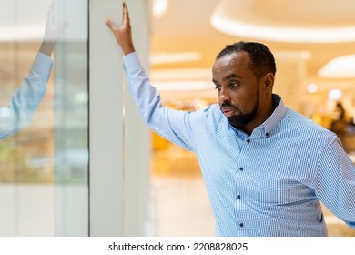 Black Man Looking Through Window While Thinking