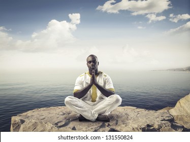 Black Man Meditating With Legs Crossed