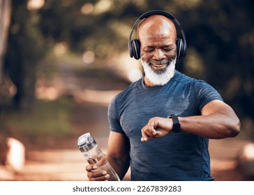 Black man, music headphones and fitness watch with a water bottle and smile outdoor for cardio time. Senior person outdoor with smartwatch for exercise, workout and training for health and wellness - Powered by Shutterstock