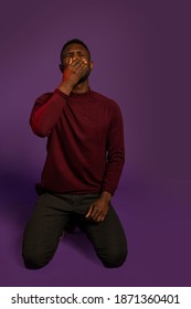 Black Man On Knees With Hand Covering Face Crying. Full Length. Isolated Studio Shot. 