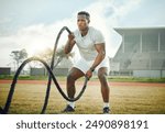 Black man, outdoor and gym with battle ropes, field and fitness for resistance training or exercise. Male person, cardio and routine for bodybuilding, strong muscle and endurance for power or workout