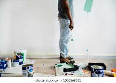 Black Man Painting House Wall