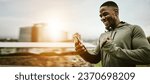 Black man, phone and technology with happy fist for notification, workout break or winner outdoor in the morning. Smartphone, person and happiness for good news, fitness deal or challenge in the city