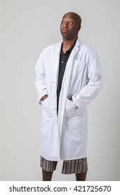 Black Man In Polo And Short, Wearing A White Lab Coat