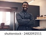 Black man, portrait smile and arms crossed in office for startup, construction business and confidence. African guy, happy architect and entrepreneur with pride, professional and urban planning job