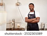 Black man, portrait and smile for baker, small business owner and pastry kitchen workshop. African chef, confidence and catering for coffee shop, retail and cafe startup for restaurant industry store