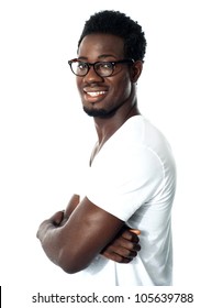Black man posing with crossed arms and wearing glasses