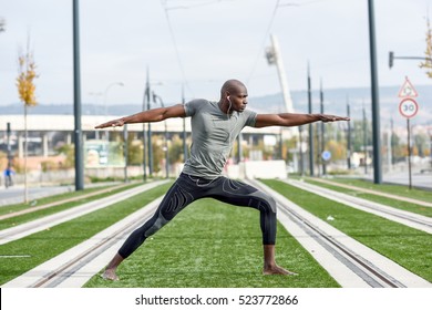 Black Man Practicing Yoga In Urban Background. African Male Doing Workout Outdoors.