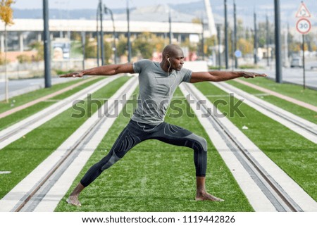 Similar – Black man practicing yoga in urban background.