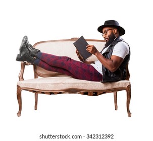 Black Man Reading On A Sofa
