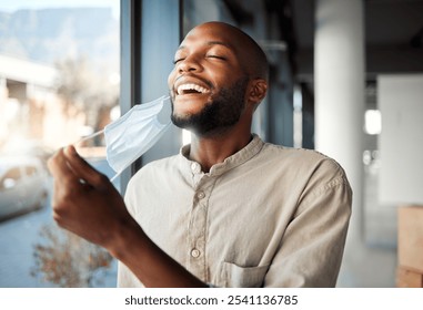 Black man, remove or smile with face mask for safety, pandemic or fresh air in healthcare awareness. Breathing, protection and illness prevention in office break for covid disease, virus and bacteria - Powered by Shutterstock