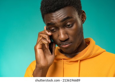 Black Man With A Sad Face Talking On The Phone In Studio