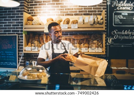 Image, Stock Photo African man works in pastry shop.