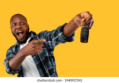 Black Man Showing New Car Key Posing On Yellow Background