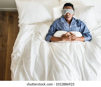 Black Man Sleeping On Bed With Eye Mask