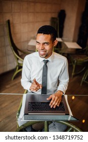 Black Man Smiles You Finger Up, The Laptop Can Not, Look At The Camera  In A White Shirt, Indoor, 