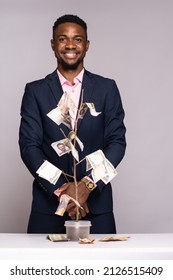 Black Man Standing Behind A Money Tree