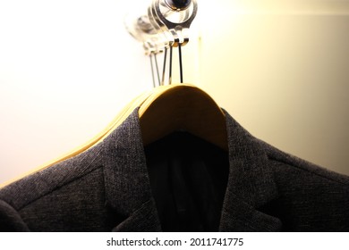 Black Man Suit Hanged In Closet Under The Yelow Light