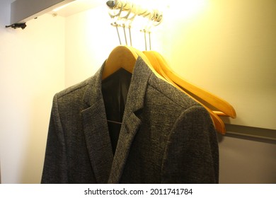 Black Man Suit Hanged In Closet Under The Yelow Light