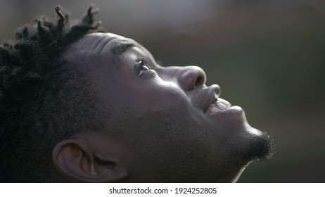 Black Man Taking A Deep Breath Outside And Opening Eyes Looking Up At Sky Smiling Feeling Free