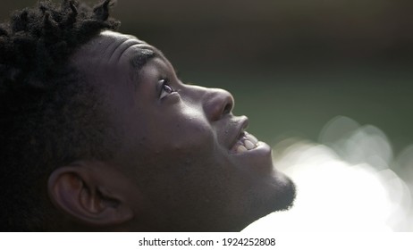 Black Man Taking A Deep Breath Outside And Opening Eyes Looking Up At Sky Smiling Feeling Free