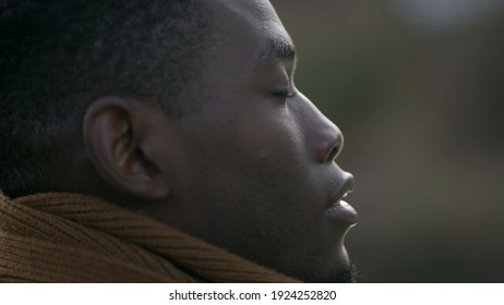 Black Man Taking A Deep Breath Outside And Opening Eyes Looking Up At Sky Smiling Feeling Free