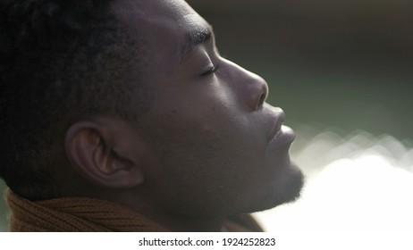 Black Man Taking A Deep Breath Outside And Opening Eyes Looking Up At Sky Smiling Feeling Free