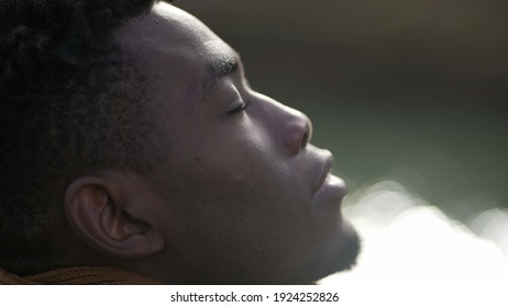 Black Man Taking A Deep Breath Outside And Opening Eyes Looking Up At Sky Smiling Feeling Free