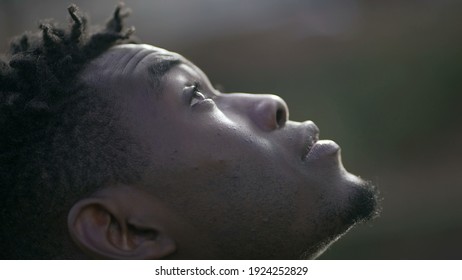 Black Man Taking A Deep Breath Outside And Opening Eyes Looking Up At Sky Smiling Feeling Free