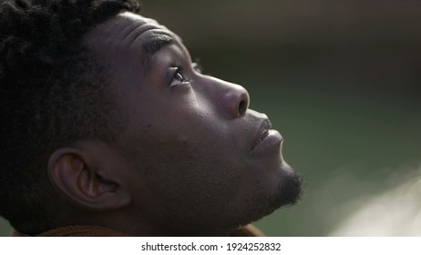 Black Man Taking A Deep Breath Outside And Opening Eyes Looking Up At Sky Smiling Feeling Free