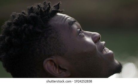 Black Man Taking A Deep Breath Outside And Opening Eyes Looking Up At Sky Smiling Feeling Free