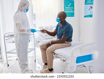 Black Man Talking To Doctor, With Covid Mask And Getting Medical Wellness Advice At Hospital Or Clinic. Expert, Professional Or Healthcare Worker Helping Patient, Doing Checkup And Giving Brochure