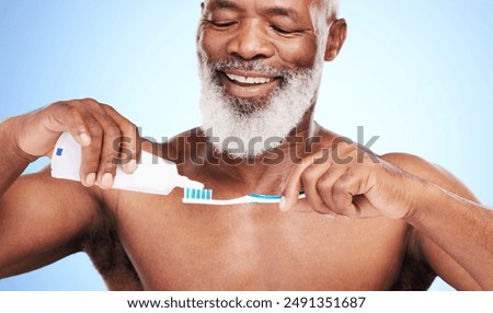 Black man, toothbrush and toothpaste in studio for brushing teeth, dental care and fresh breath. Mature person, happy and oral on blue background with mouth hygiene for wellness, white or bacteria